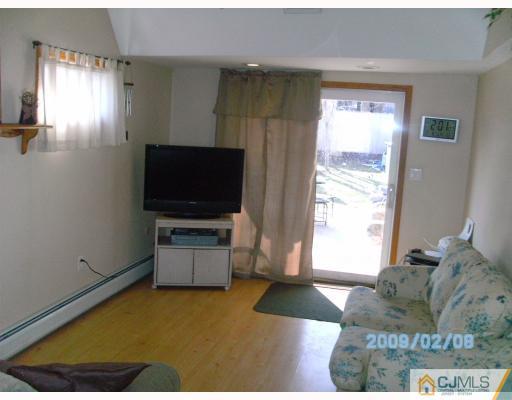 24 Stony Road Edison, NJ 08817 - Photo 5 of 7 a living room with furniture and a flat screen tv
