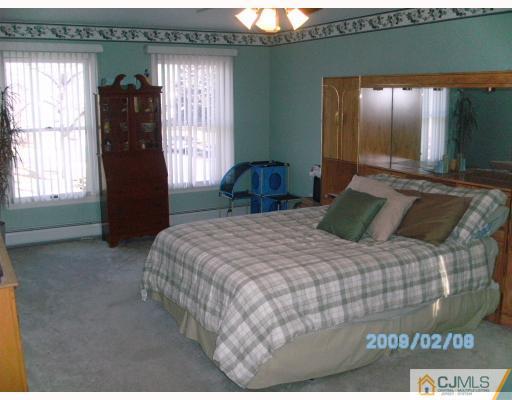 24 Stony Road Edison, NJ 08817 - Photo 6 of 7 a bedroom with a bed and a large window