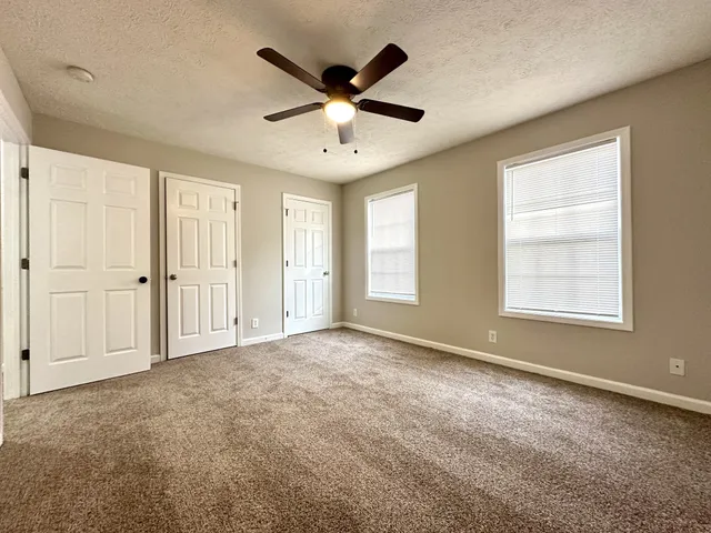 a bathroom with a granite countertop sink toilet a shower and a bathtub