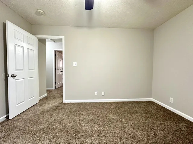 an empty room with a empty space and a ceiling fan