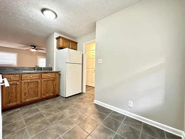 a kitchen with a refrigerator and cabinets