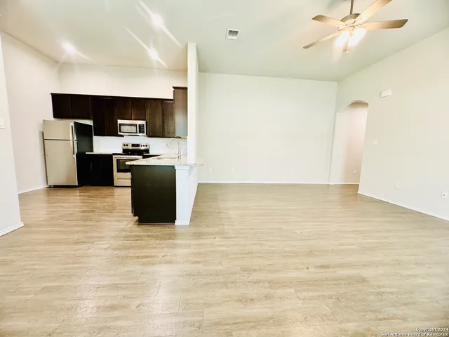 a kitchen with stainless steel appliances a refrigerator and a stove