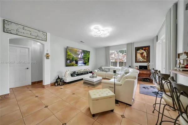 a living room with furniture and a flat screen tv