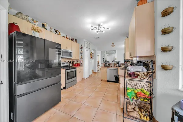 a kitchen with a refrigerator and a stove