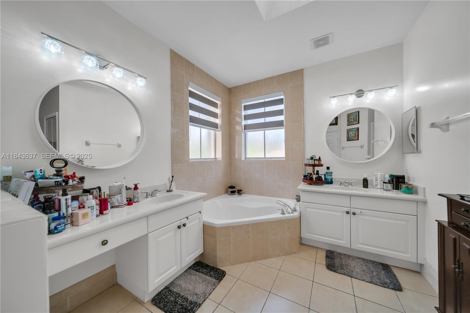 12355 Southwest 124th Terrace Miami, FL 33186 - Photo 28 of 38 a bathroom with a double vanity sink mirror and bathtub