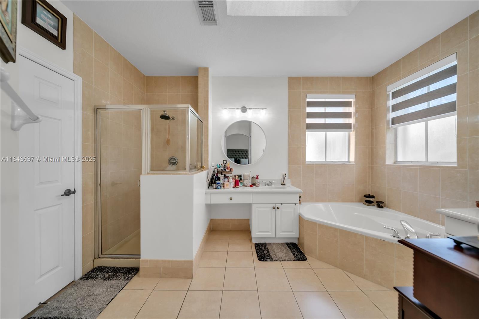 12355 Southwest 124th Terrace Miami, FL 33186 - Photo 29 of 38 a large white bathroom with a sink mirror and bathtub