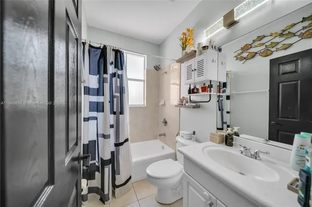 a bedroom with a large bed and a book shelf
