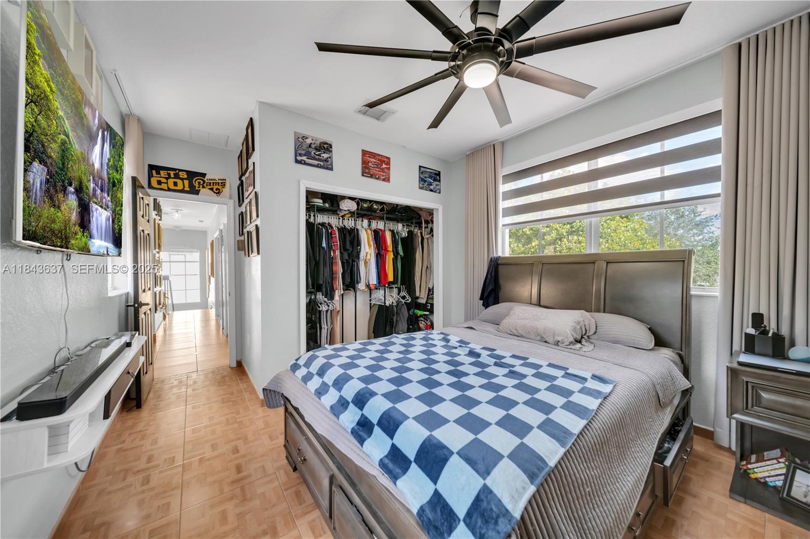 12355 Southwest 124th Terrace Miami, FL 33186 - Photo 35 of 38 a bedroom with a large bed and a book shelf