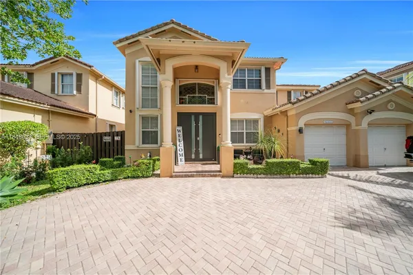 a front view of a house with a garden