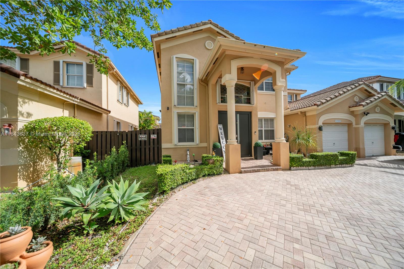 12355 Southwest 124th Terrace Miami, FL 33186 - Photo 8 of 38 a front view of a house with a garden