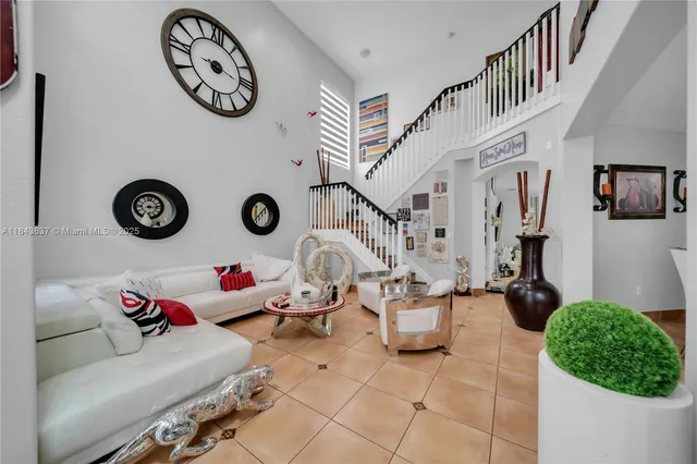 a living room with patio furniture and a clock