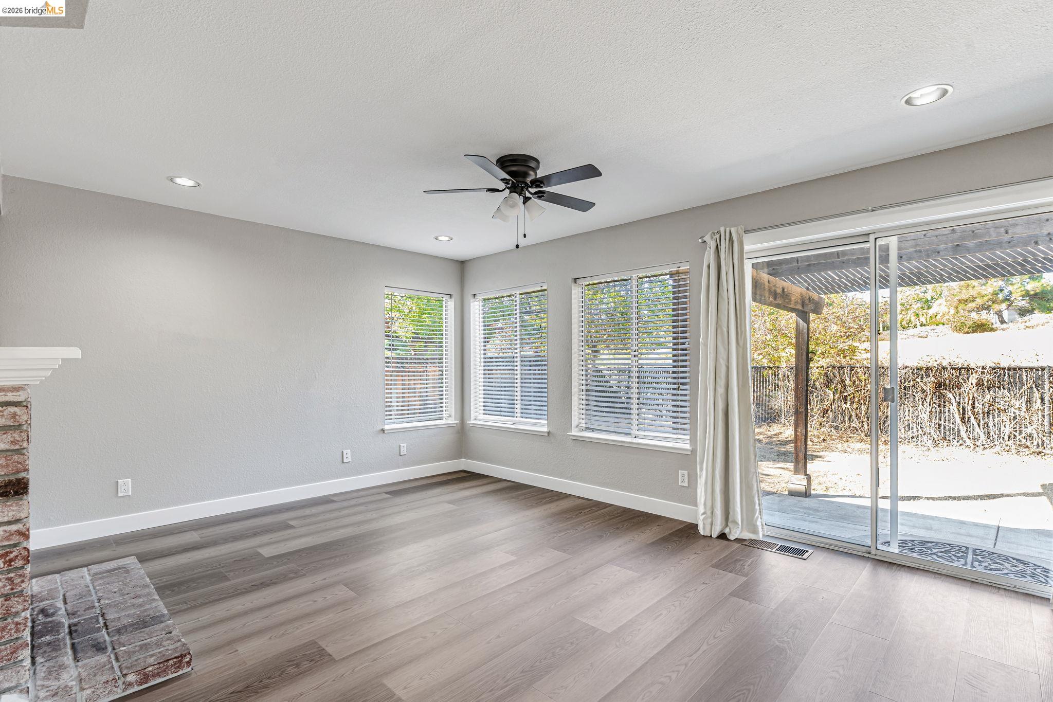 5052 Perry Way Antioch, CA 94531 - Photo 13 of 51 a view of an empty room with a window and wooden floor