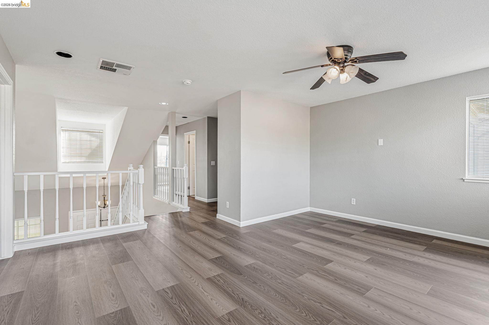 5052 Perry Way Antioch, CA 94531 - Photo 23 of 51 a view of an empty room with wooden floor and a ceiling fan