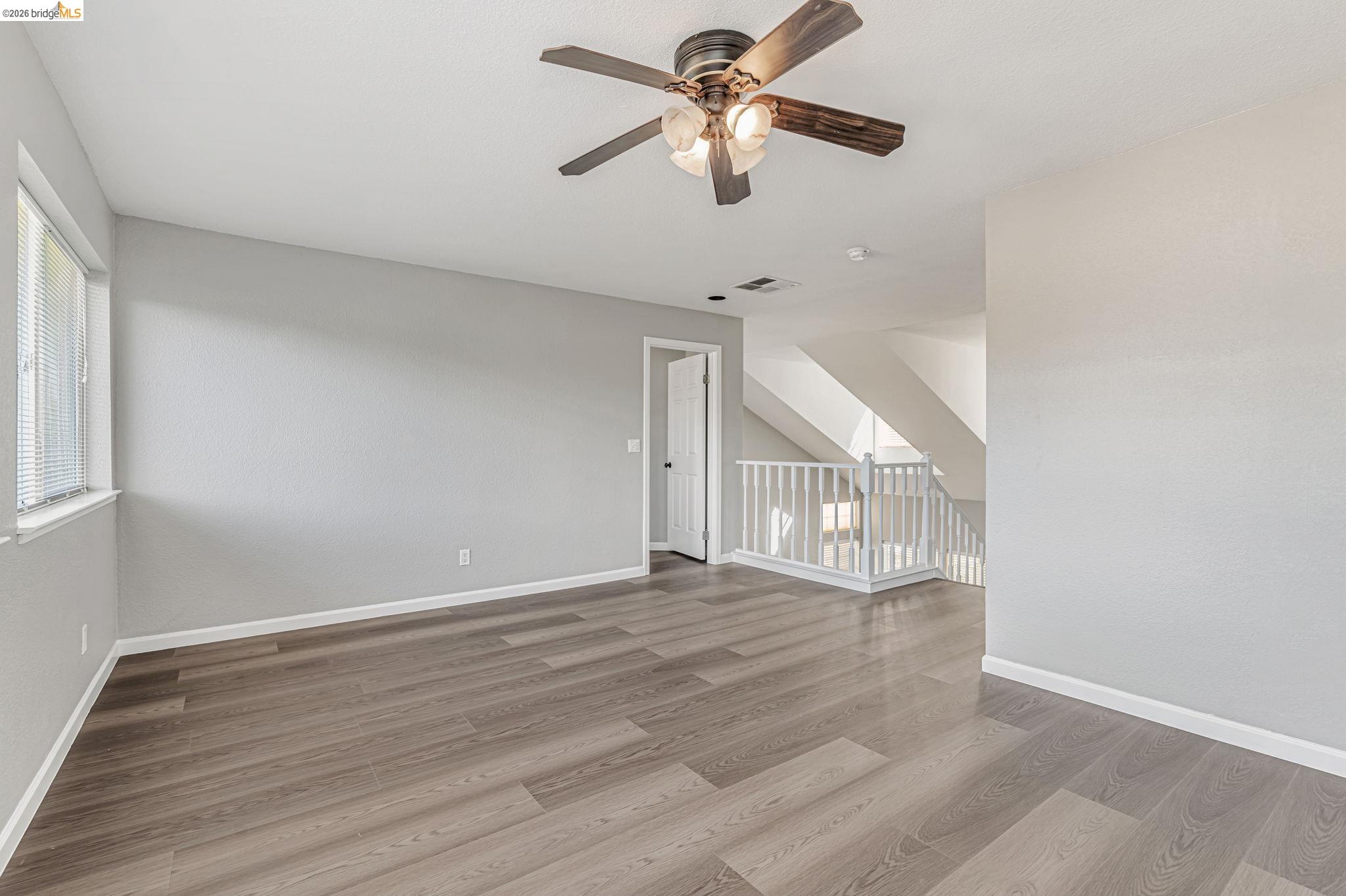 5052 Perry Way Antioch, CA 94531 - Photo 24 of 51 a view of empty room with wooden floor and fan