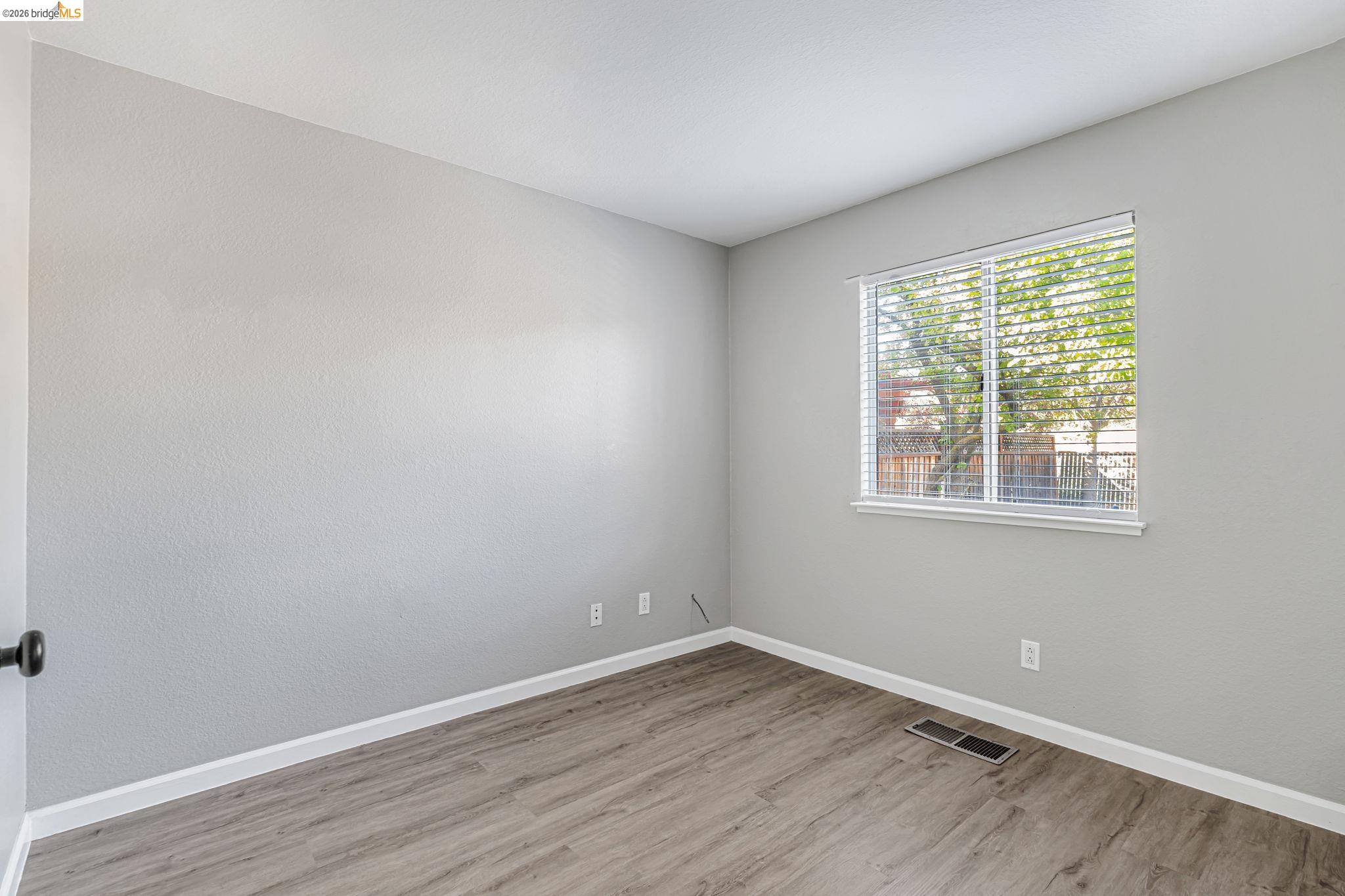 5052 Perry Way Antioch, CA 94531 - Photo 28 of 51 an empty room with wooden floor and windows