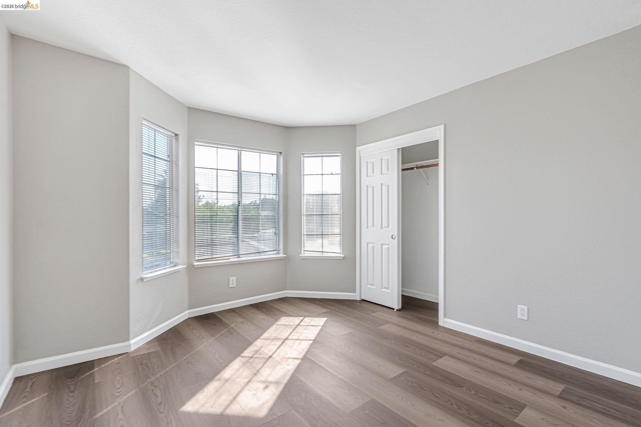 5052 Perry Way Antioch, CA 94531 - Photo 32 of 51 an empty room with wooden floor and windows