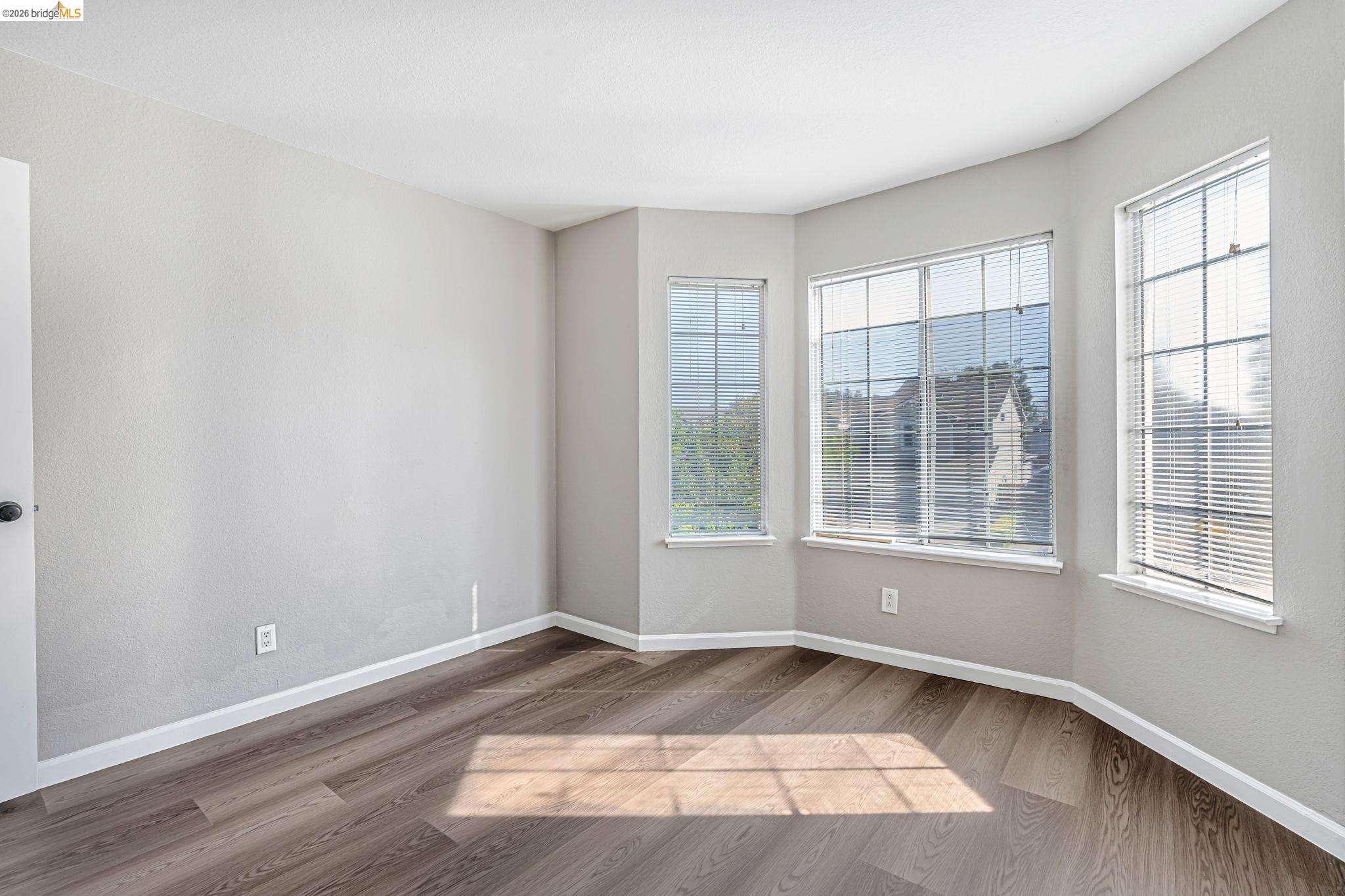 5052 Perry Way Antioch, CA 94531 - Photo 33 of 51 an empty room with wooden floor and windows