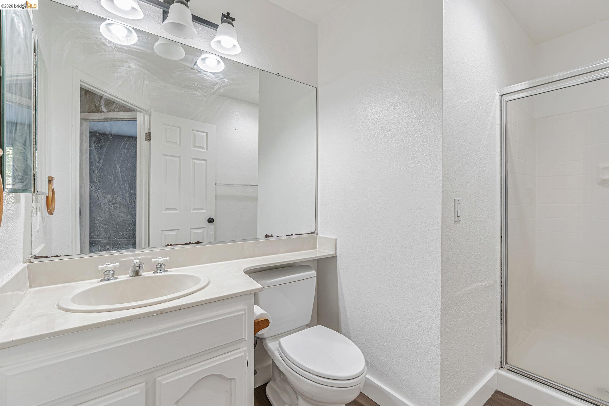 5052 Perry Way Antioch, CA 94531 - Photo 43 of 51 a bathroom with a sink toilet a mirror and shower