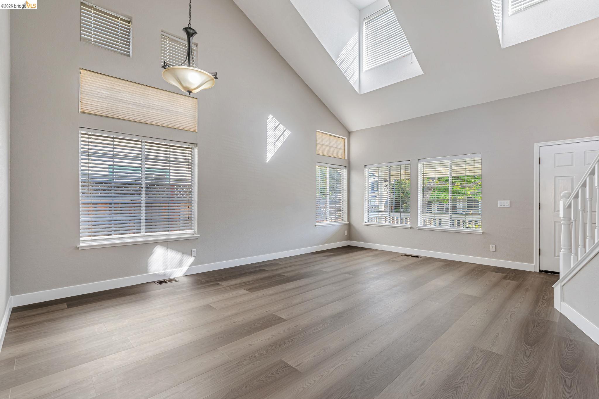5052 Perry Way Antioch, CA 94531 - Photo 9 of 51 an empty room with wooden floor and windows