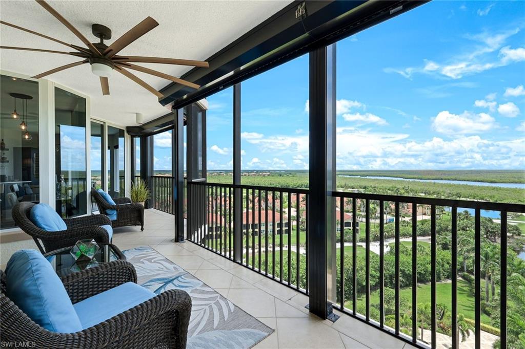 1060 Borghese Lane, Unit 902 Naples, FL 34114 - Photo 1 of 24 a living room with furniture tv and a large window