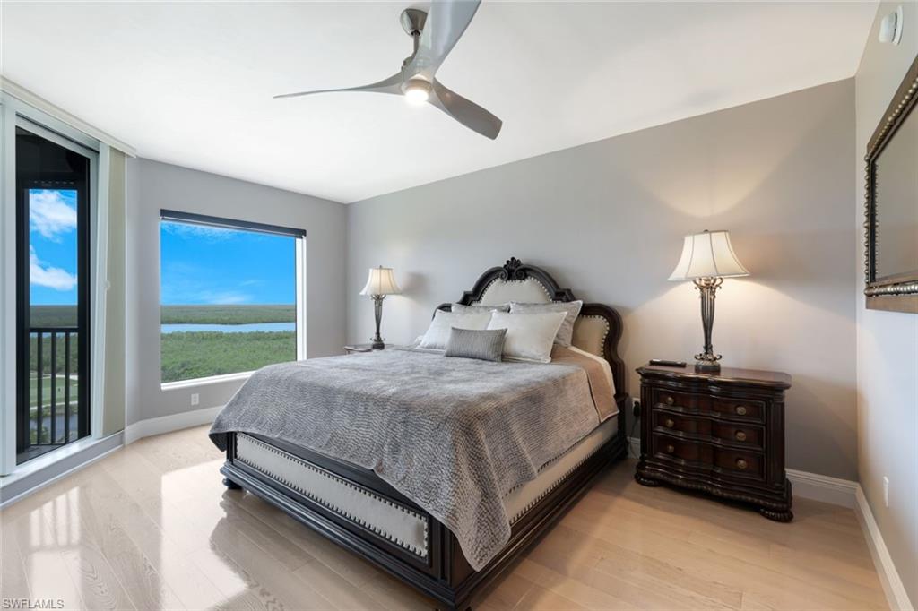 1060 Borghese Lane, Unit 902 Naples, FL 34114 - Photo 13 of 24 a bed room with a bed and a night stand