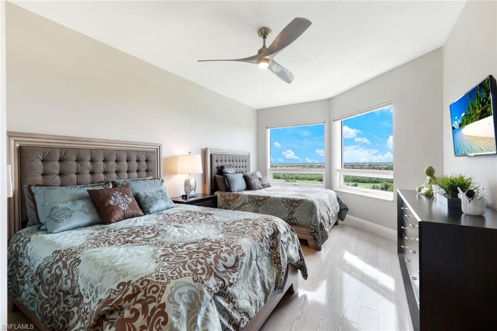 1060 Borghese Lane, Unit 902 Naples, FL 34114 - Photo 16 of 24 a bedroom with a large bed and a window