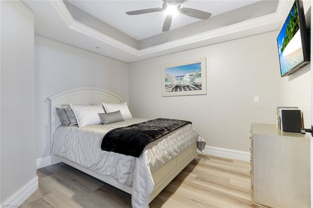 1060 Borghese Lane, Unit 902 Naples, FL 34114 - Photo 18 of 24 a bedroom with a bed and a flat screen tv
