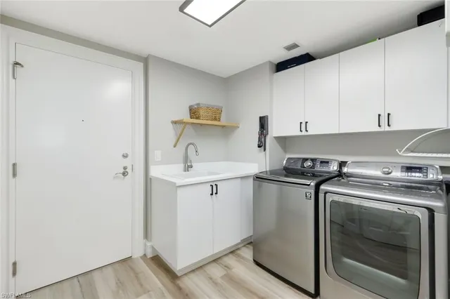 a kitchen with a stove sink and cabinets