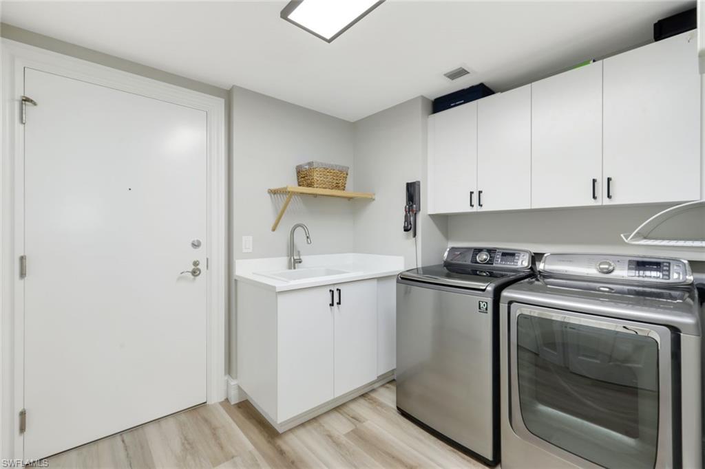 1060 Borghese Lane, Unit 902 Naples, FL 34114 - Photo 20 of 24 a kitchen with a stove sink and cabinets