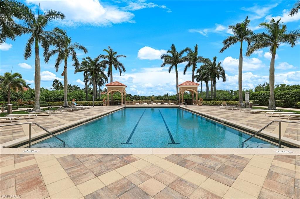 1060 Borghese Lane, Unit 902 Naples, FL 34114 - Photo 22 of 24 a view of swimming pool with palm trees