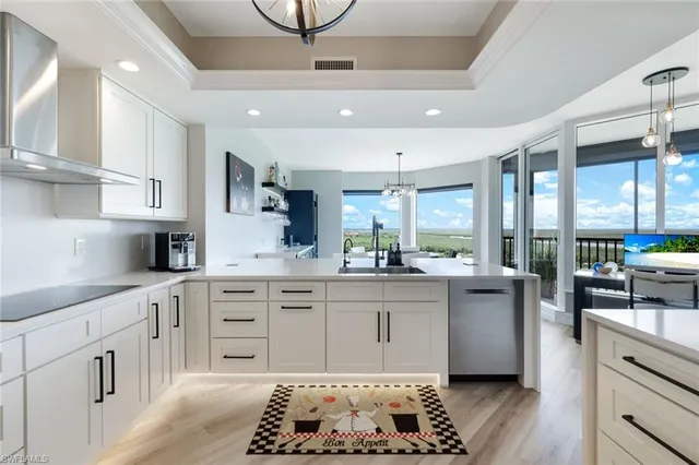 a kitchen with stainless steel appliances kitchen island granite countertop a sink and cabinets