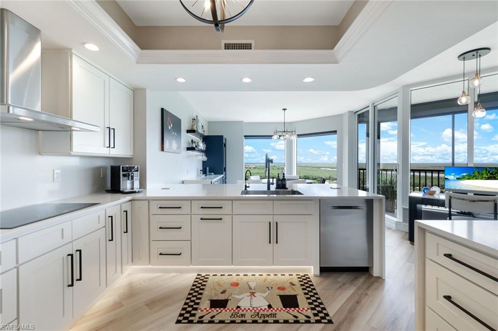 1060 Borghese Lane, Unit 902 Naples, FL 34114 - Photo 4 of 24 a kitchen with stainless steel appliances kitchen island granite countertop a sink and cabinets