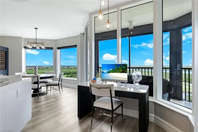 a room with furniture and large windows