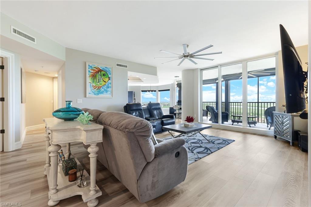 1060 Borghese Lane, Unit 902 Naples, FL 34114 - Photo 10 of 24 a living room with furniture and a large window
