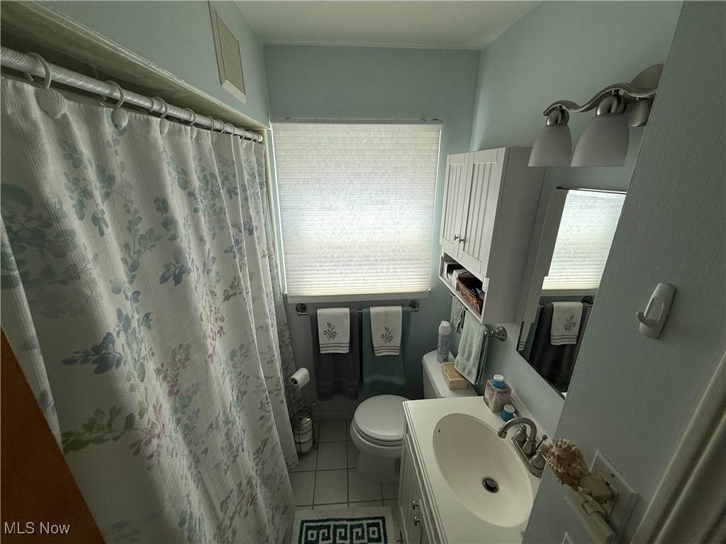 6289 Manchester Road Parma, OH 44129 - Photo 21 of 46 Full bath featuring light tile patterned flooring, vanity, plenty of natural light, and a shower with shower curtain