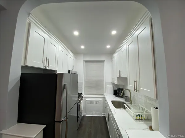 a kitchen with stainless steel appliances a refrigerator sink and stove