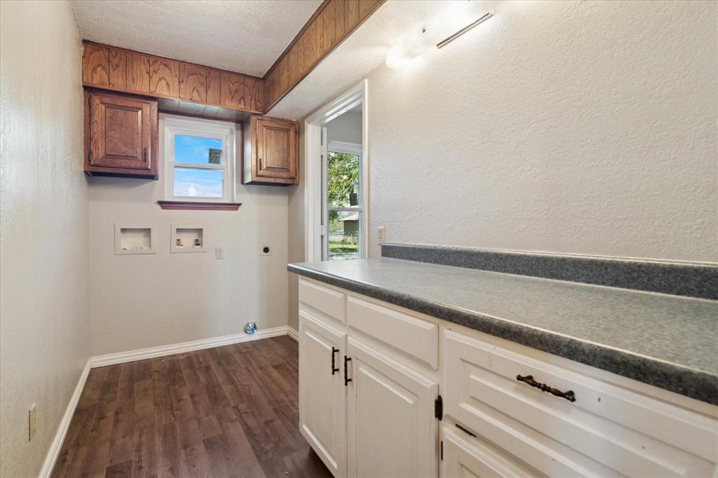 2300 Union Hill Road Sanger, TX 76266 - Photo 14 of 34 a kitchen with a wooden floor and cabinets