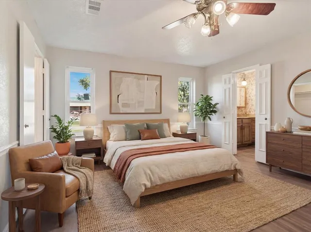 a spacious bedroom with a large bed and a chandelier