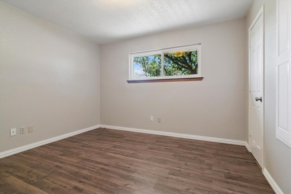 2300 Union Hill Road Sanger, TX 76266 - Photo 23 of 34 a view of an empty room with wooden floor and a window