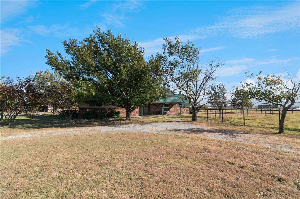 2300 Union Hill Road Sanger, TX 76266 - Photo 4 of 34 a view of swimming pool with a yard and trees in the background