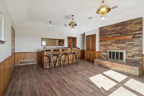 a view of a livingroom with furniture wooden floor and window