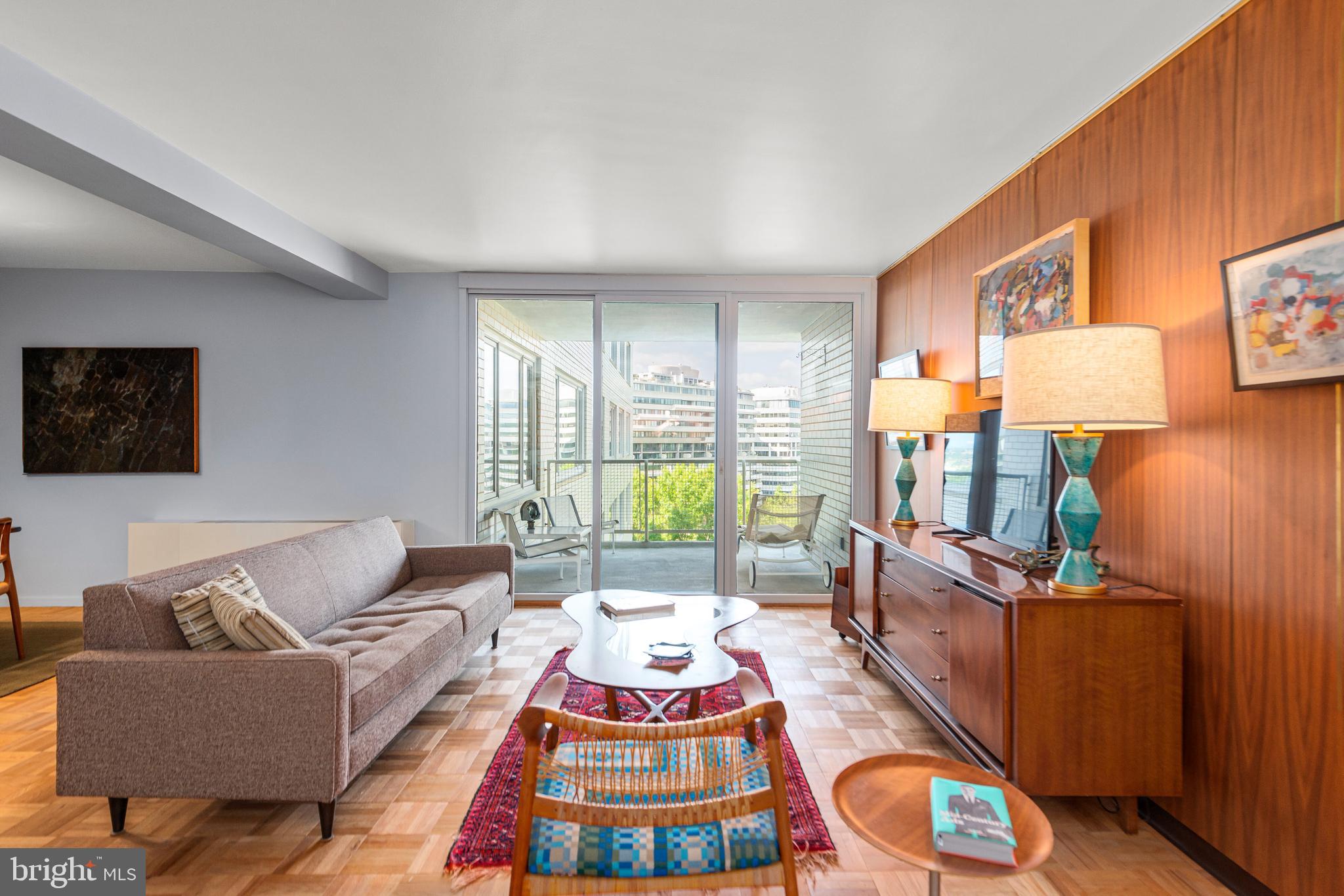 a living room with furniture and a lamp