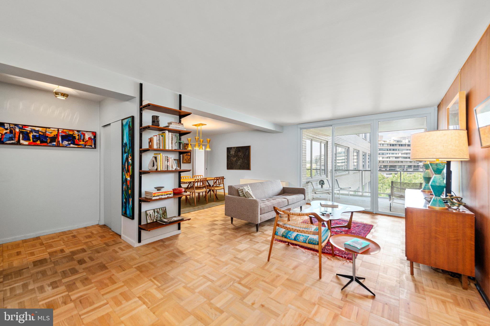 2475 Virginia Avenue Northwest, Unit 700 Washington, DC 20037 - Photo 2 of 36 a living room with furniture a rug and a flat screen tv