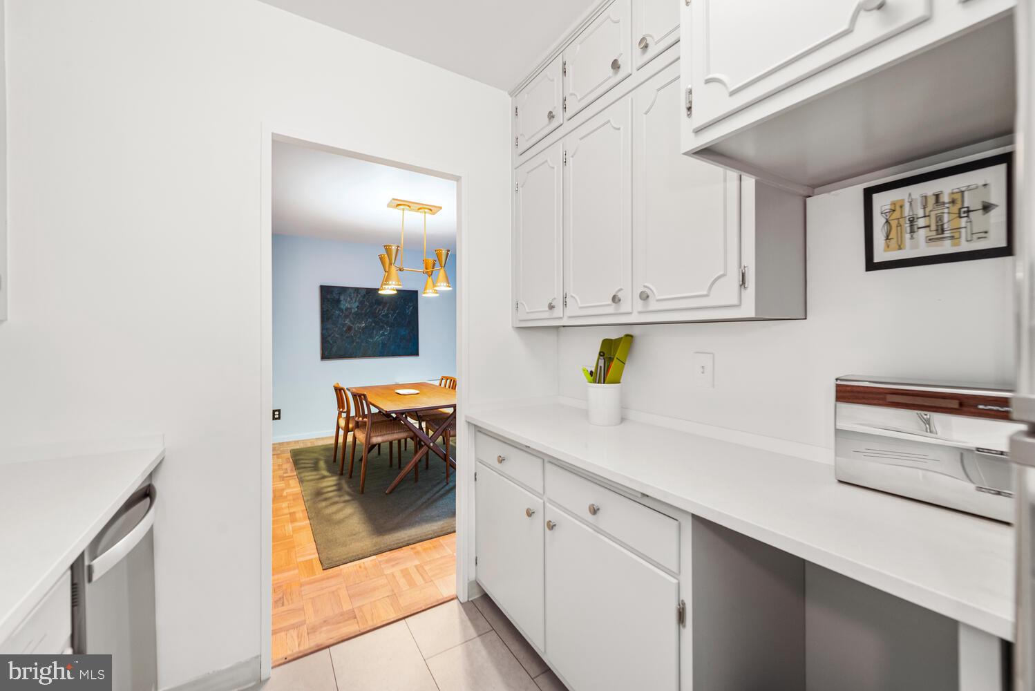 2475 Virginia Avenue Northwest, Unit 700 Washington, DC 20037 - Photo 15 of 36 a kitchen with stainless steel appliances white cabinets and a refrigerator