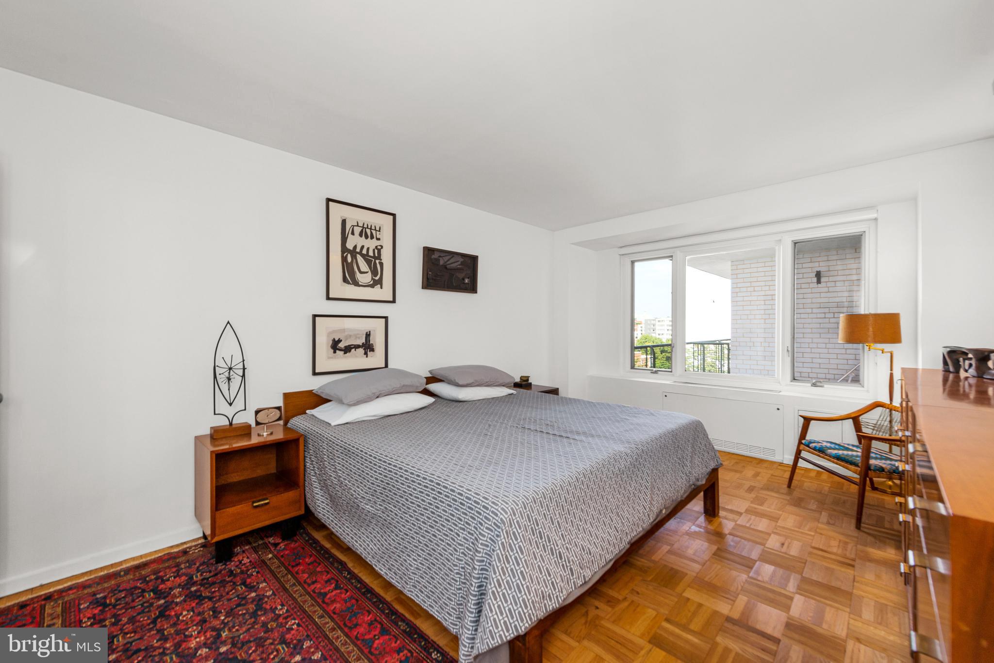 2475 Virginia Avenue Northwest, Unit 700 Washington, DC 20037 - Photo 16 of 36 a bedroom with a bed and wooden floor