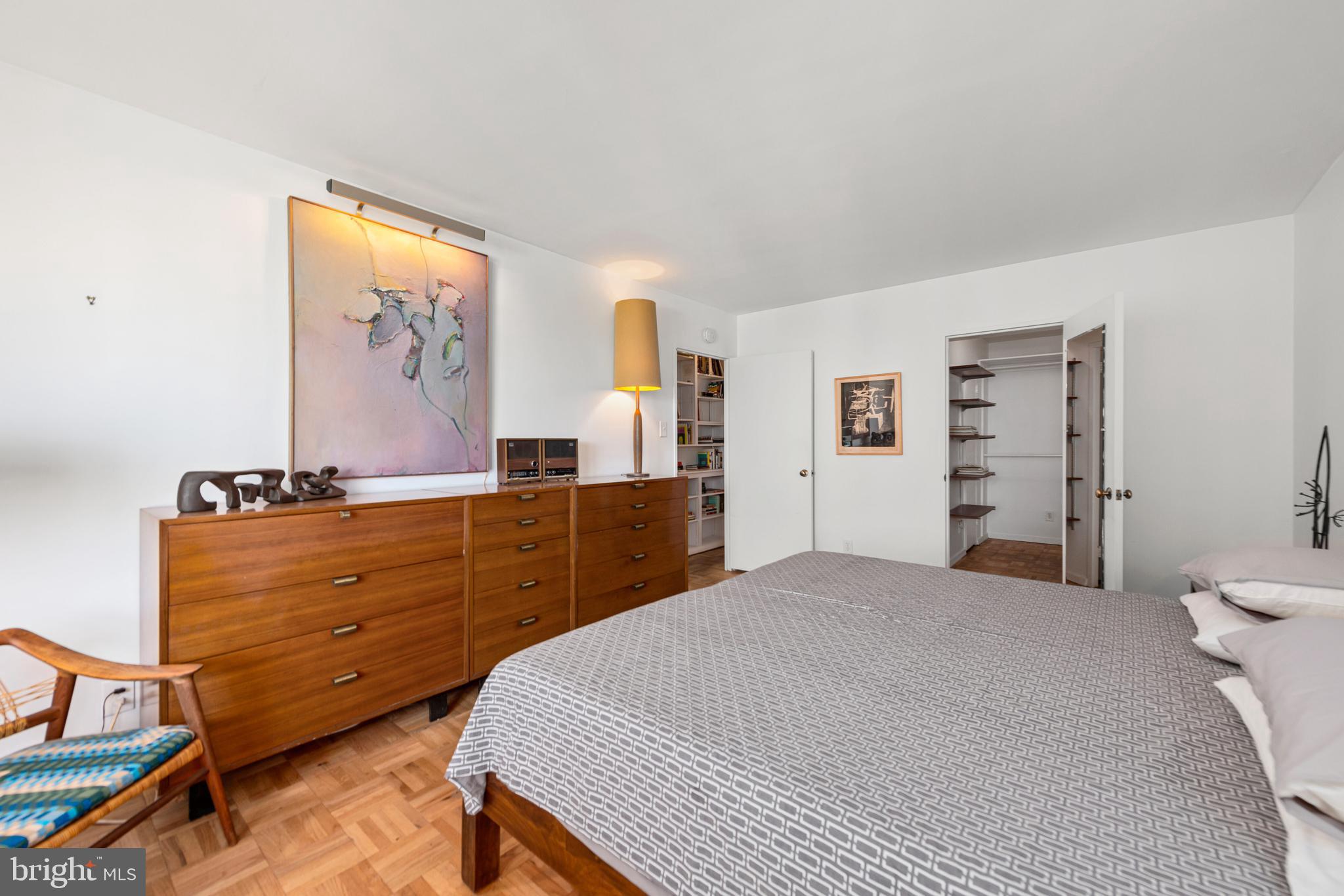 2475 Virginia Avenue Northwest, Unit 700 Washington, DC 20037 - Photo 18 of 36 a bedroom with a bed and a dresser