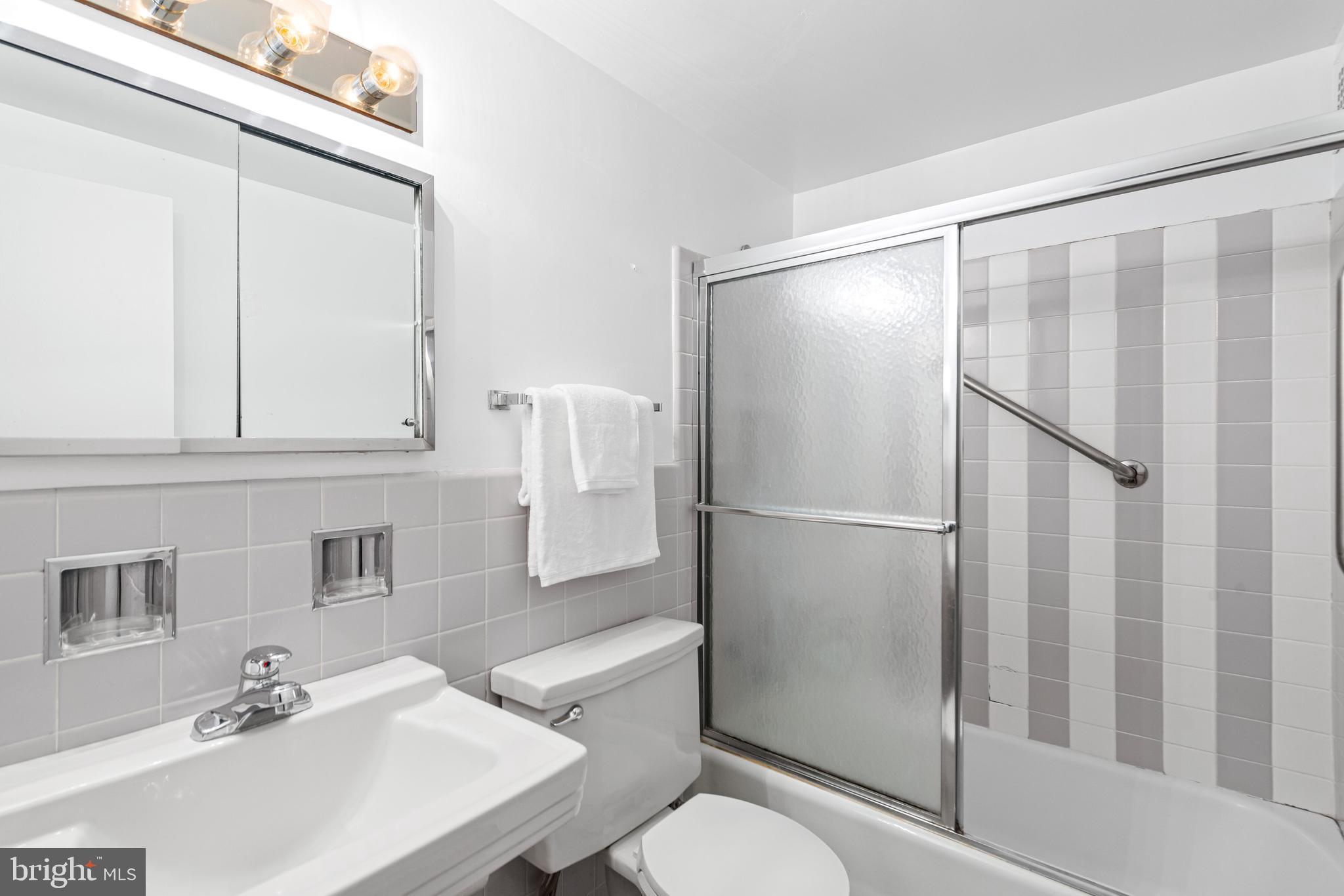 2475 Virginia Avenue Northwest, Unit 700 Washington, DC 20037 - Photo 20 of 36 a bathroom with a sink toilet and shower