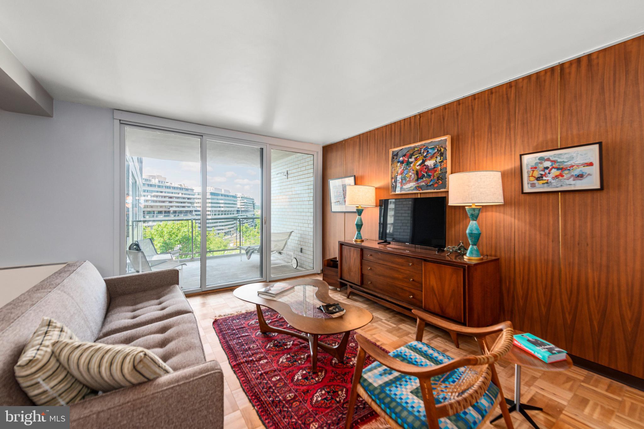 2475 Virginia Avenue Northwest, Unit 700 Washington, DC 20037 - Photo 3 of 36 a living room with furniture and a flat screen tv