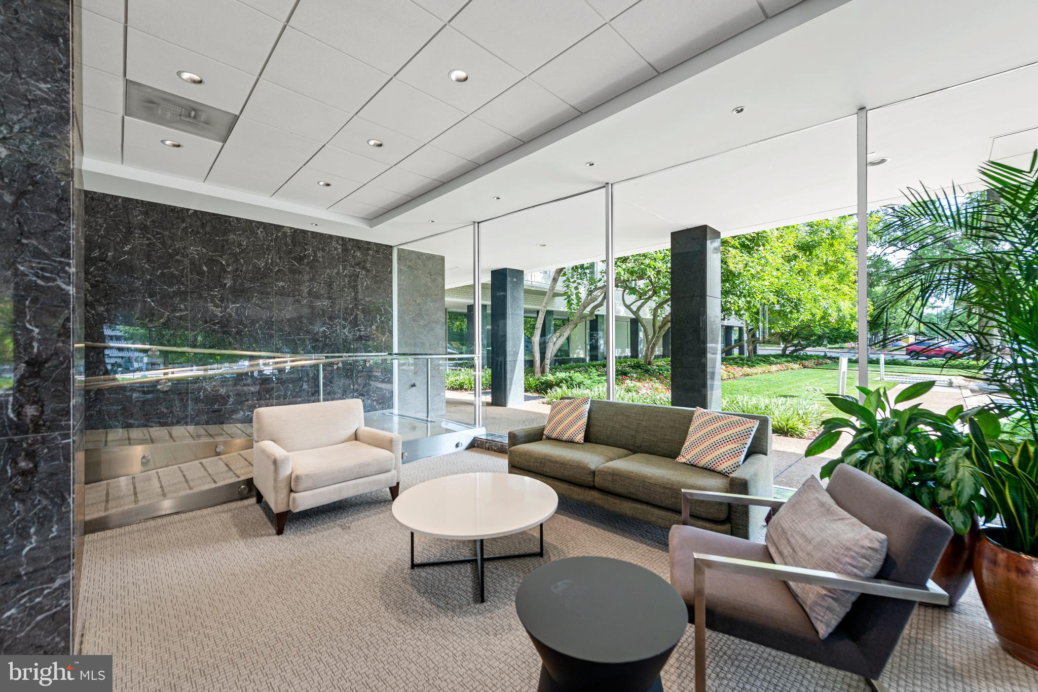 2475 Virginia Avenue Northwest, Unit 700 Washington, DC 20037 - Photo 24 of 36 a living room with patio furniture and a garden
