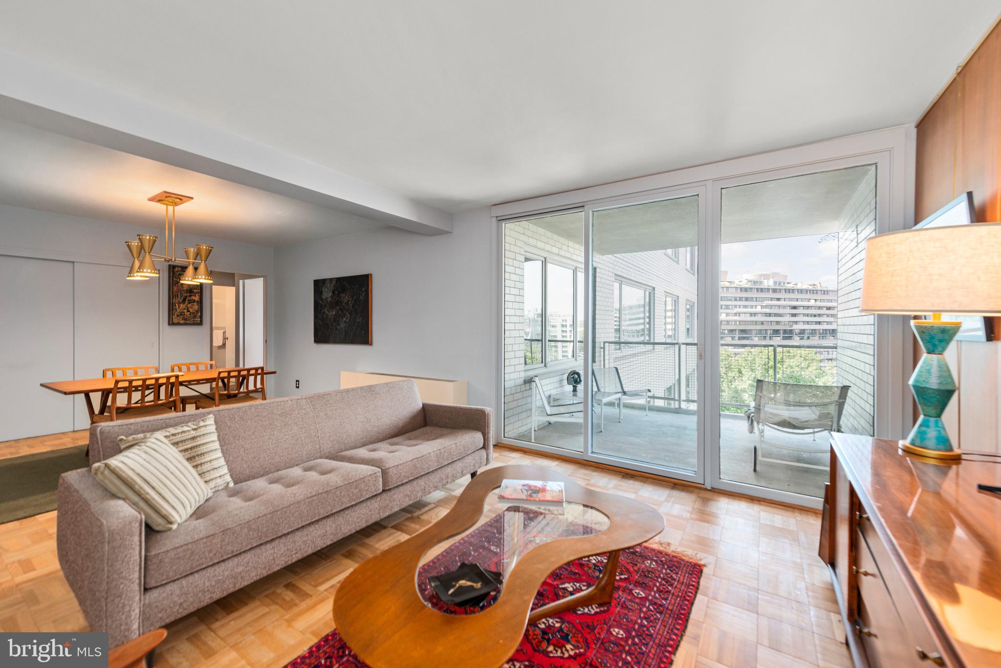 2475 Virginia Avenue Northwest, Unit 700 Washington, DC 20037 - Photo 4 of 36 a living room with furniture and a floor to ceiling window